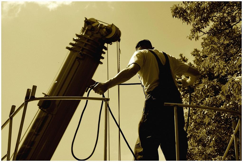 Technician performing maintenance on an outdoor compressor unit